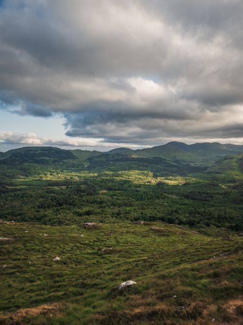 Free Breathtaking view of Ireland's lush green hills under a dramatic sky. Stock Photo