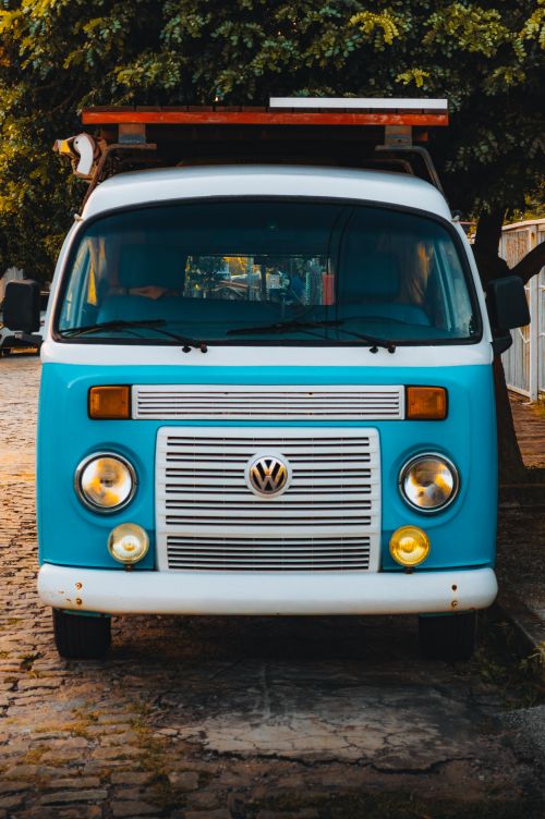 Free Front view of a classic blue Volkswagen van parked on a cobblestone street in Natal, Brazil. Stock Photo
