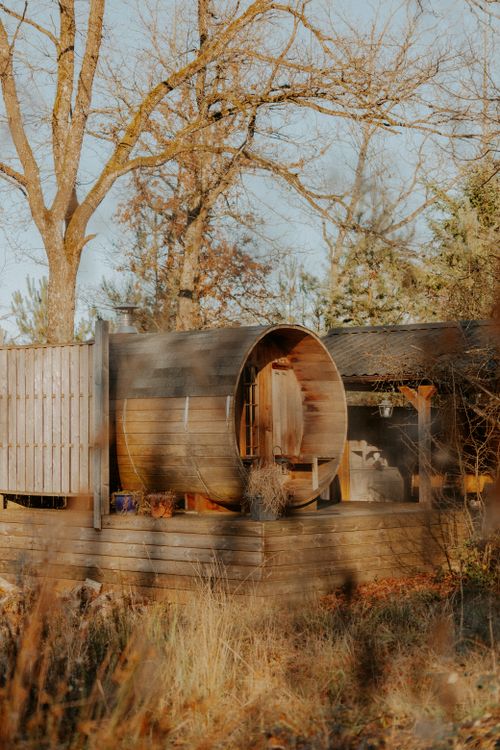 Free A wooden barrel sauna in a serene winter garden setting in La Roche-en-Ardenne, Belgium. Stock Photo