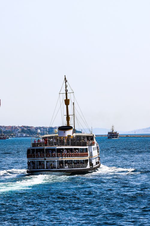 Free A ferry navigates the Bosphorus Strait under clear skies in Istanbul, Türkiye. Stock Photo