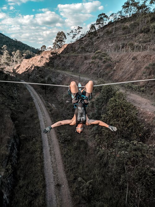 Man In Black Tank Top Hanging On A Rope