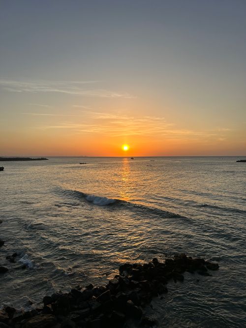 Free Golden sunset over the Indian Ocean at Kovalam Beach, Kerala, with gentle waves in view. Stock Photo