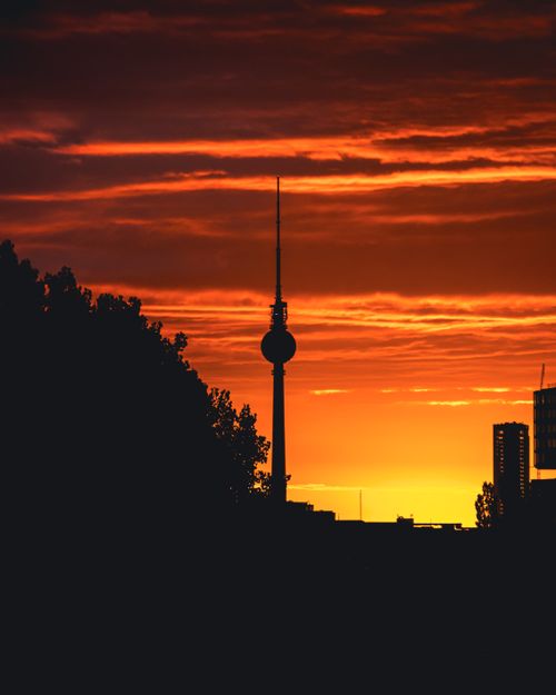 Free Silhouette of Berlin's TV Tower against a vibrant sunset sky. Stock Photo