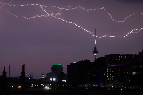 Free Striking lightning over Berlin's skyline, highlighting the city's vibrant architecture at night. Stock Photo