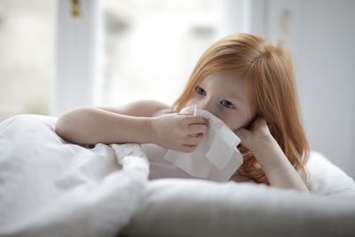 Sick child with cold in bed