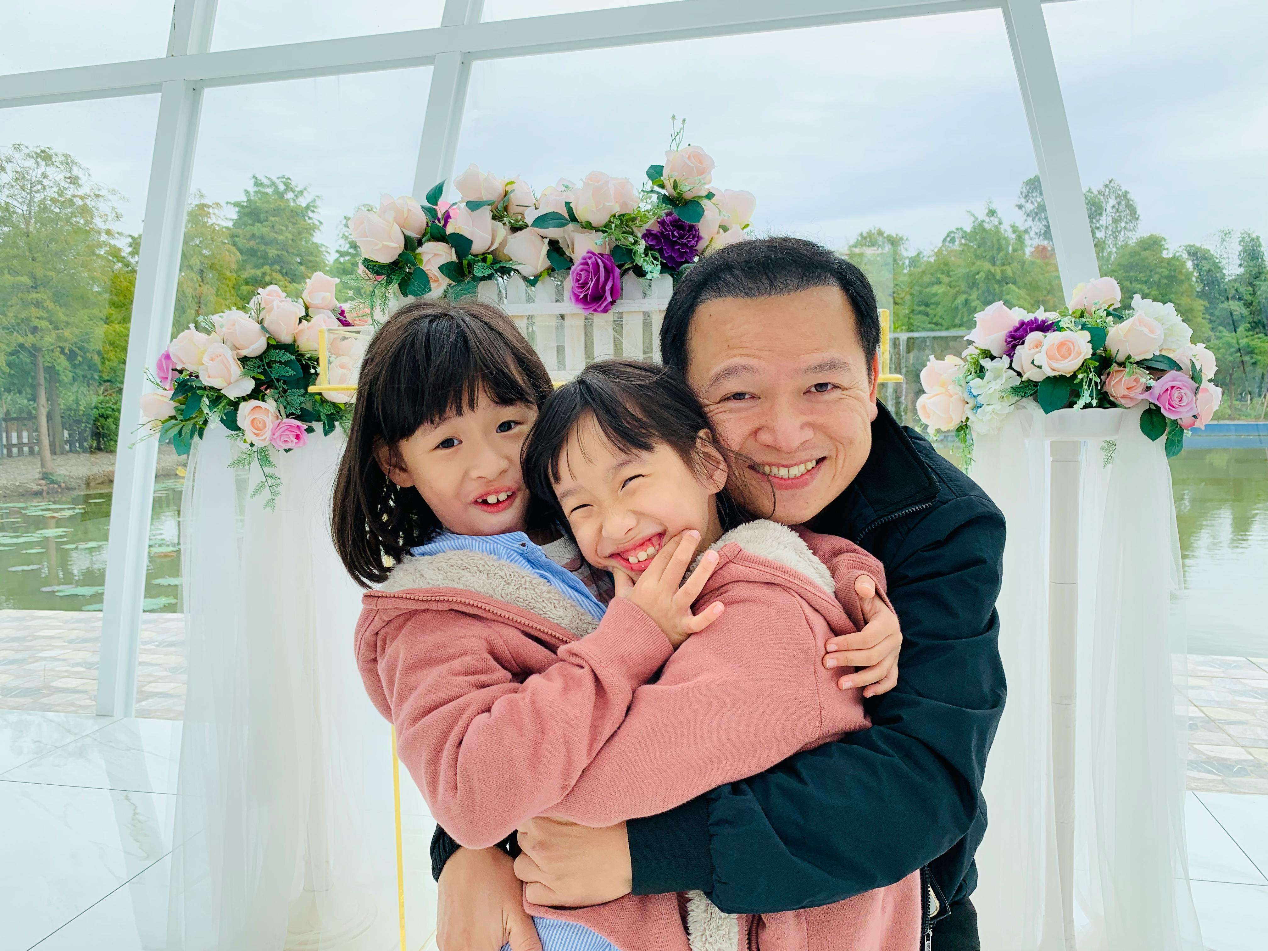 portrait of two girls with their father