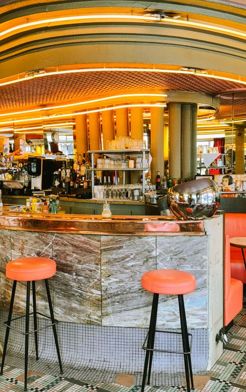 Free Stylish and vibrant cafe interior in Paris, featuring striking decor and a welcoming bar area. Stock Photo
