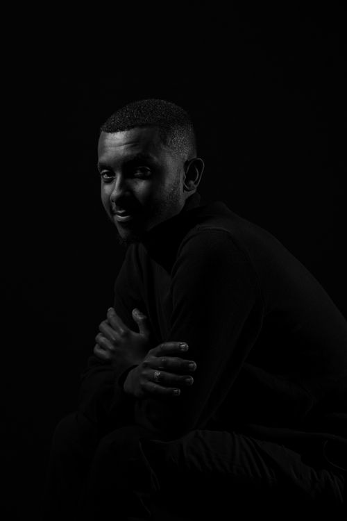 Free Dramatic black and white portrait of a man against a dark background. Stock Photo