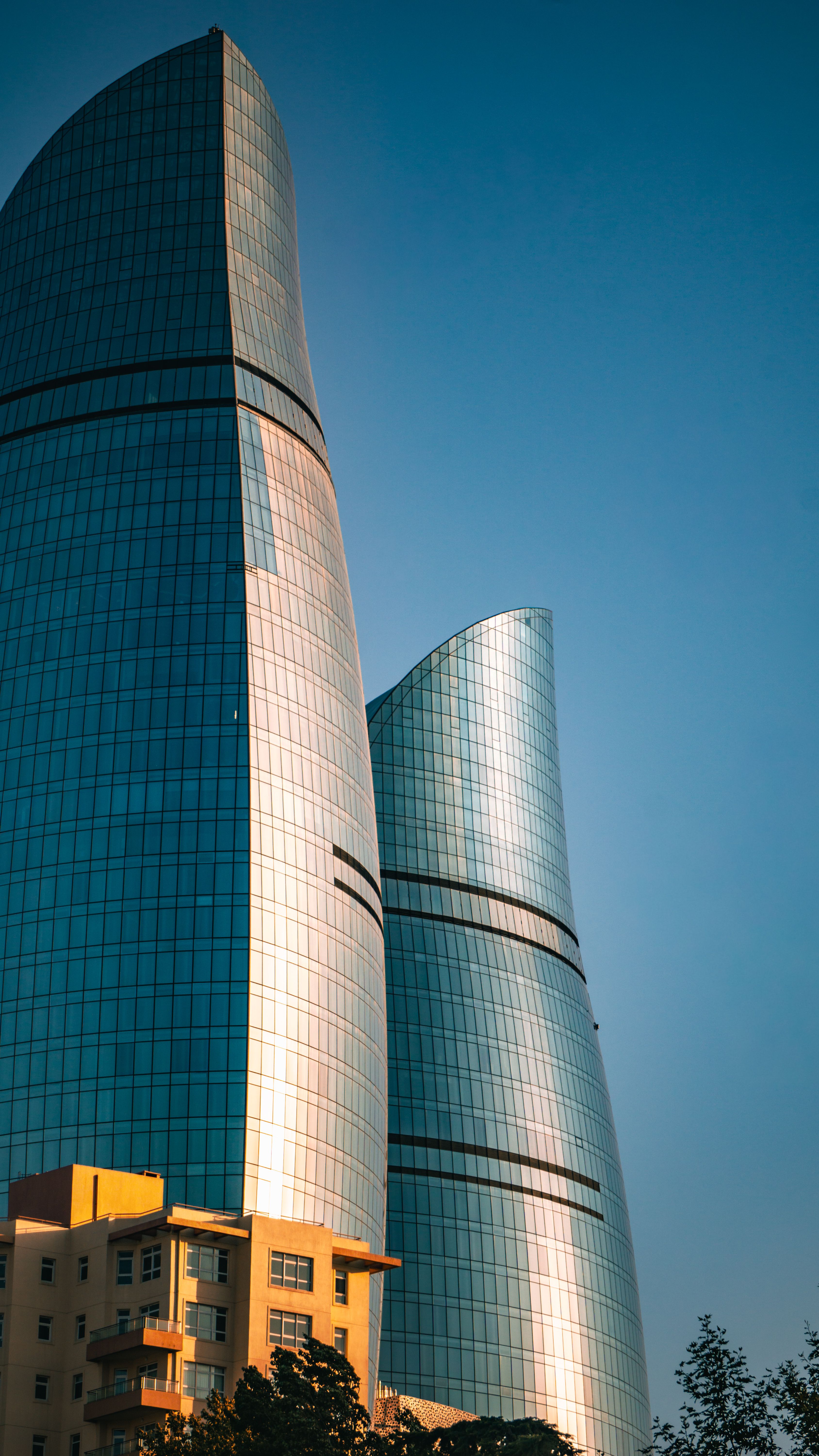 Stunning modern skyscrapers with reflective glass at sunset, showcasing architectural beauty.