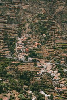 Stunning aerial view of terraced hillside and traditional village in Valle Gran Rey, Canary Islands.