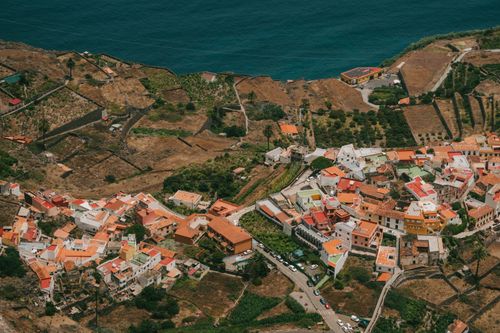 Free Aerial view of Agulo, La Gomera with colorful houses and Atlantic coastline. Stock Photo