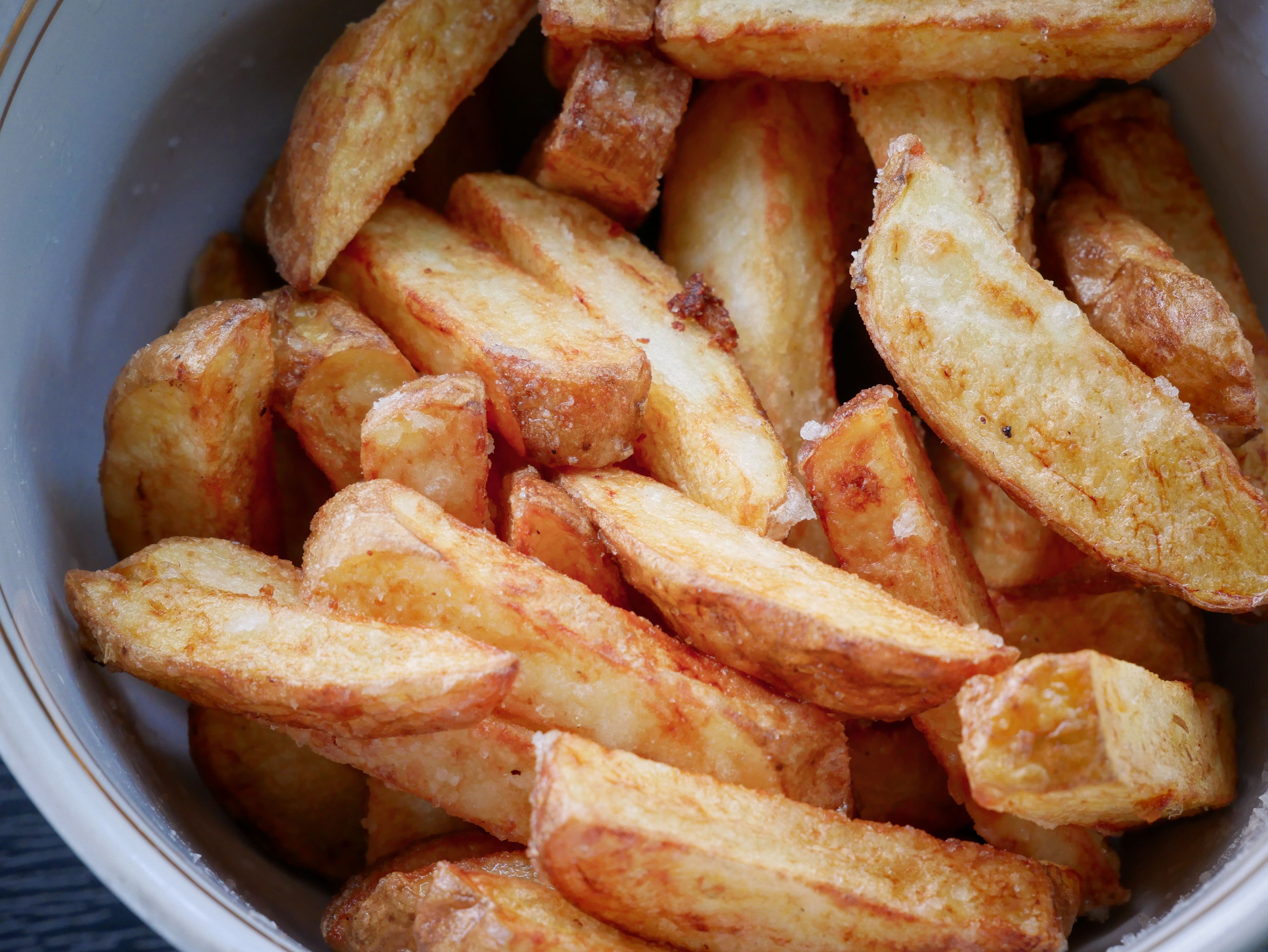 Delicious crispy potato wedges in a bowl. Perfect for snack lovers.