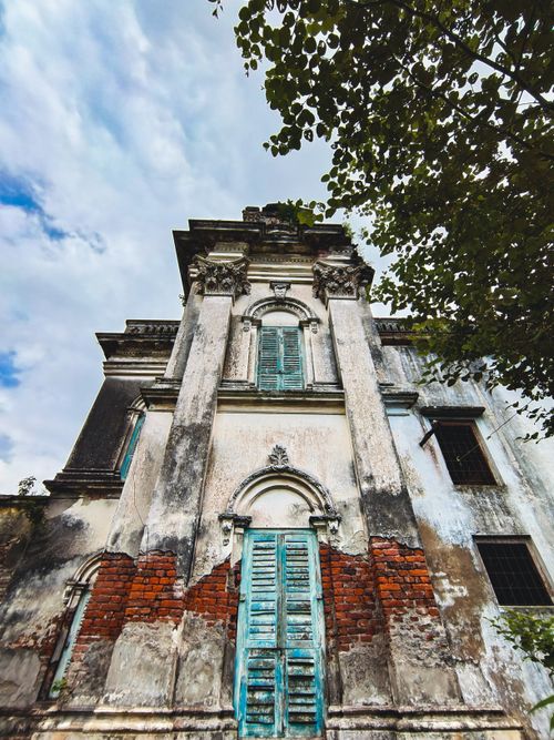 Free A weathered old building with architectural details, evocative of history and decay. Stock Photo