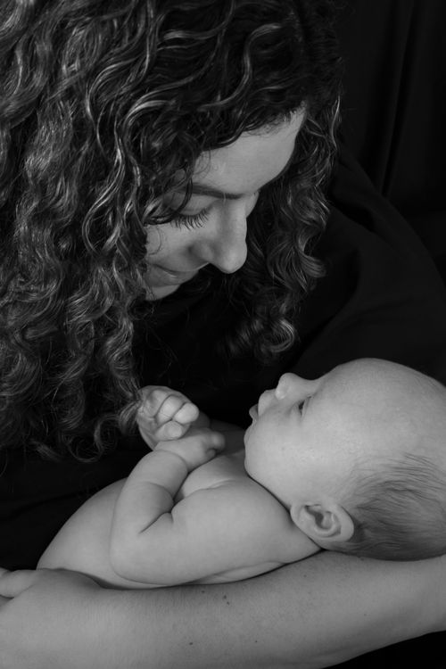 Free Heartwarming black and white portrait capturing the tender bond between a mother and newborn baby. Stock Photo