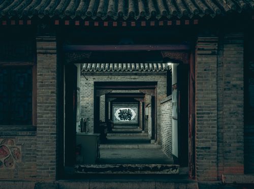 Free Serene view of a traditional Chinese courtyard featuring intricate stone carvings. Stock Photo