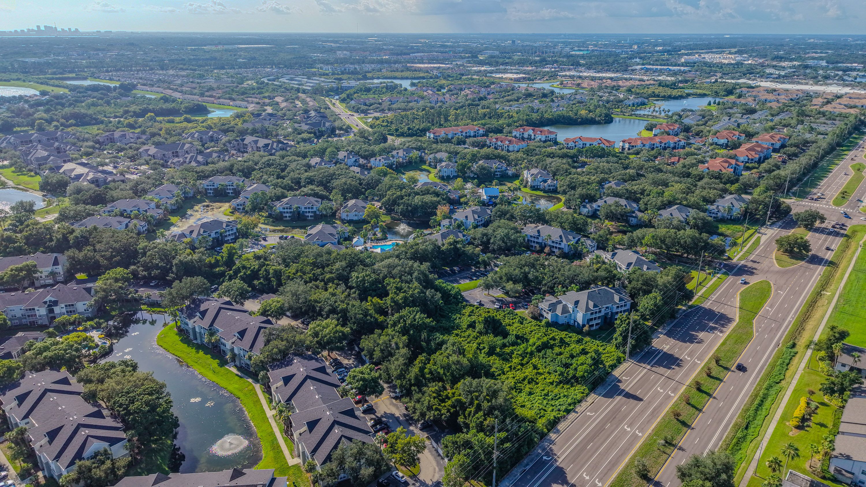 Aerial view of a suburban neighborhood with lakes and tree-lined streets