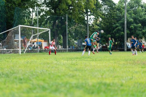 Free Youth soccer players in action during a match on a sunny day, showcasing agility and teamwork. Stock Photo