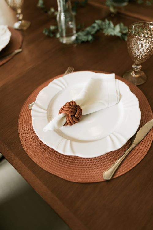Free A sophisticated dining setting featuring a white plate and decorative napkin. Stock Photo