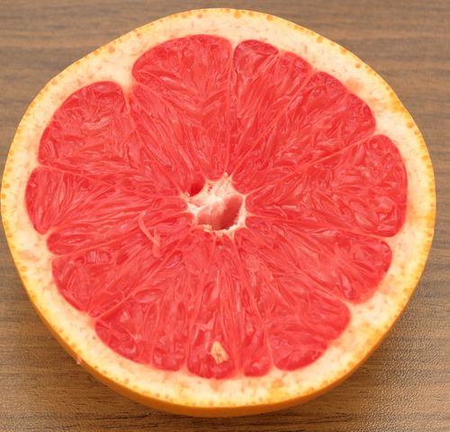Free Vibrant and juicy grapefruit half showcasing the intricate texture of the fruit's flesh. Stock Photo
