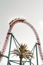 High scary roller coaster against gray sky