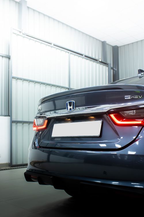 Free Close-up shot of a Honda City hybrid car in a modern Bengaluru garage. Stock Photo