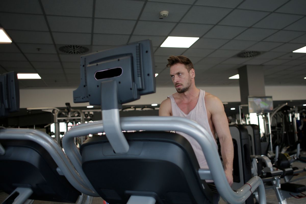 Athlete preparing for cardio training beside a treadmill