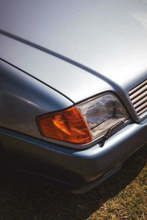 Free Close-up shot of a vintage silver Mercedes-Benz car headlight, showcasing classic design. Stock Photo