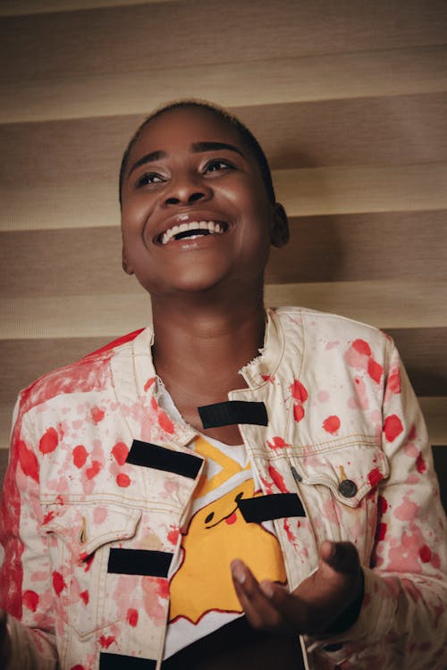 Woman in White and Red Denim Jacket Smiling