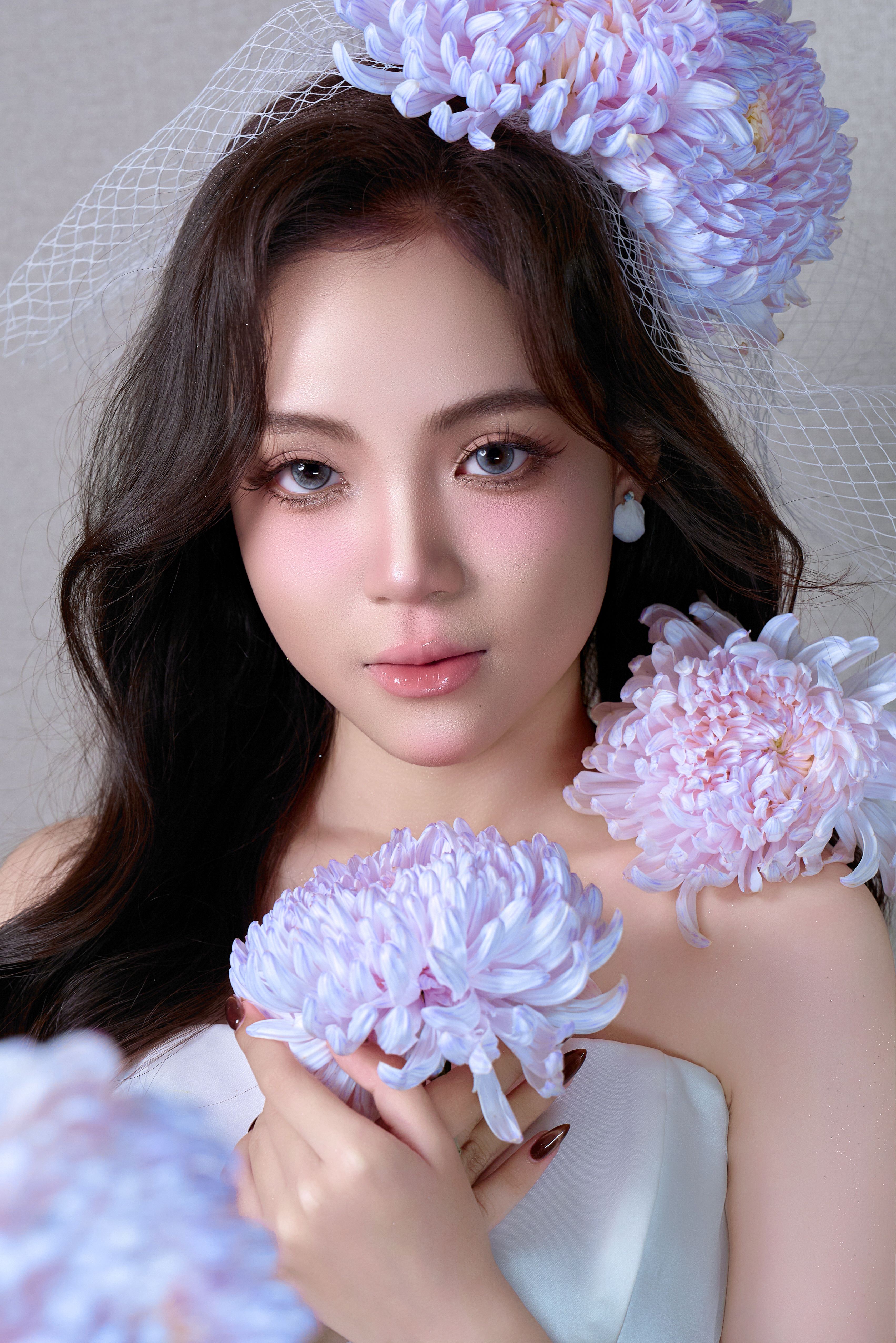 Stunning portrait of a woman adorned with chrysanthemums and a delicate veil.