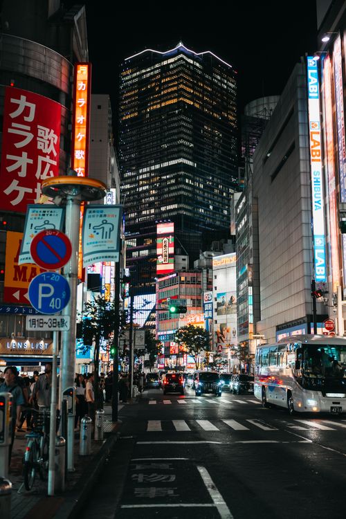 Free Dynamic urban night scene of Shibuya, Tokyo with neon signs and bustling street. Stock Photo