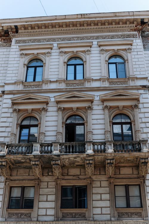 Free An ornate historical building facade featuring classical columns and arched windows in Lviv, Ukraine. Stock Photo