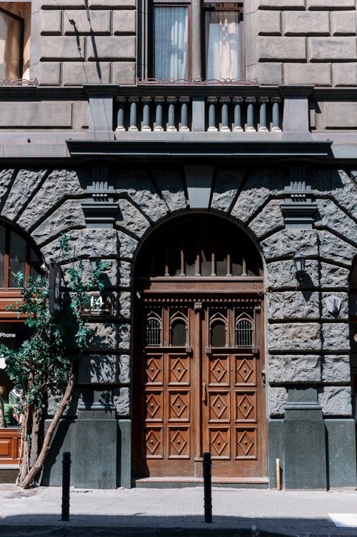 Free Ornate wooden doors of a historic building in Lviv, Ukraine, reflecting architectural elegance. Stock Photo