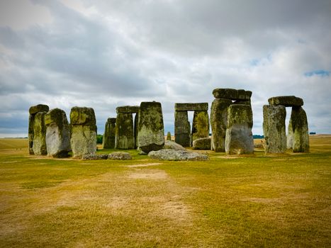 Ancient monument Stonehenge stands stoically under a cloudy sky in England.