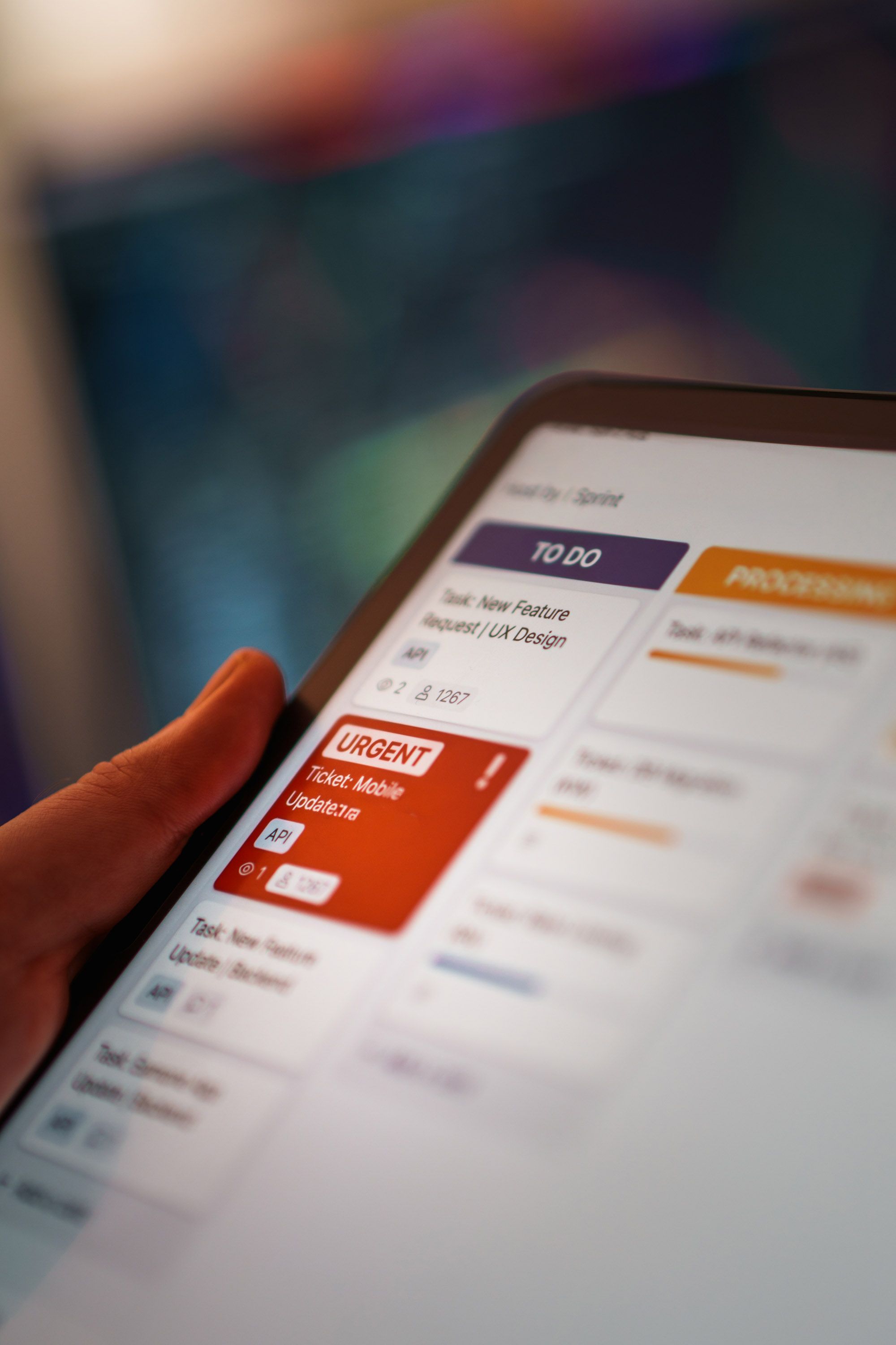 Close-up of a digital kanban board on a tablet for task management in a modern office