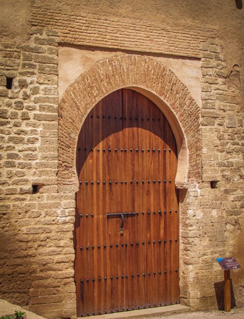 Free Ancient wooden door with arch in historic Rabat, Morocco. Stock Photo