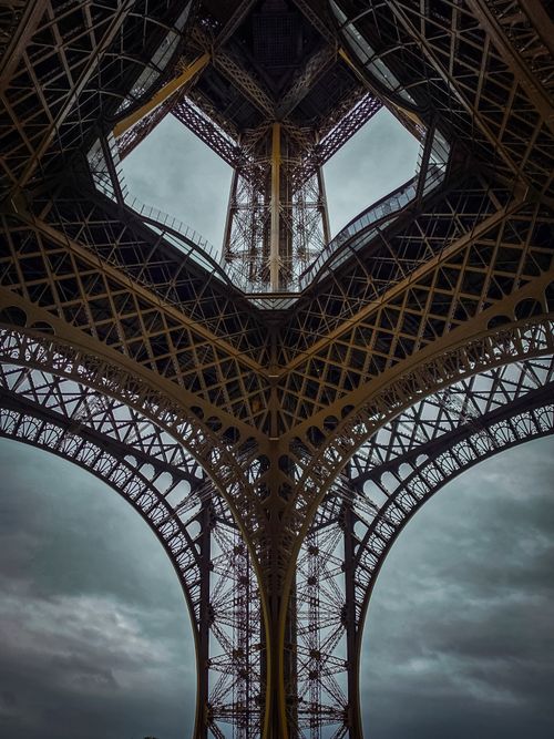 Free Dramatic view from beneath the Eiffel Tower showcasing its intricate ironwork. Stock Photo