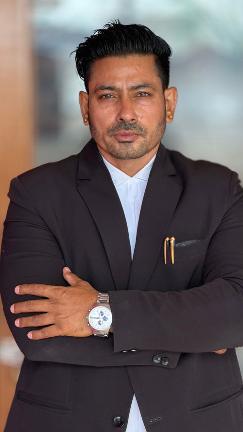 Free Professional businessman confidently posing in a black suit indoors, conveying leadership and success. Stock Photo