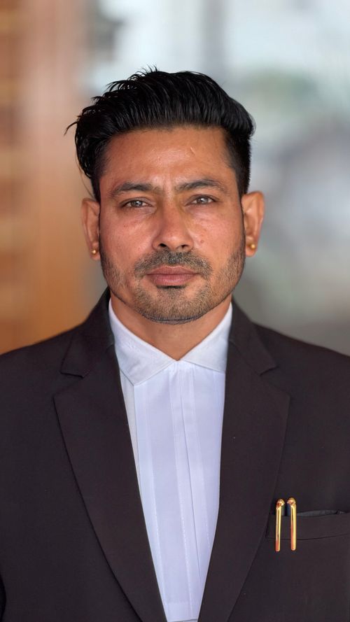 Free Portrait of a confident male in a formal suit standing against a blurred background. Stock Photo