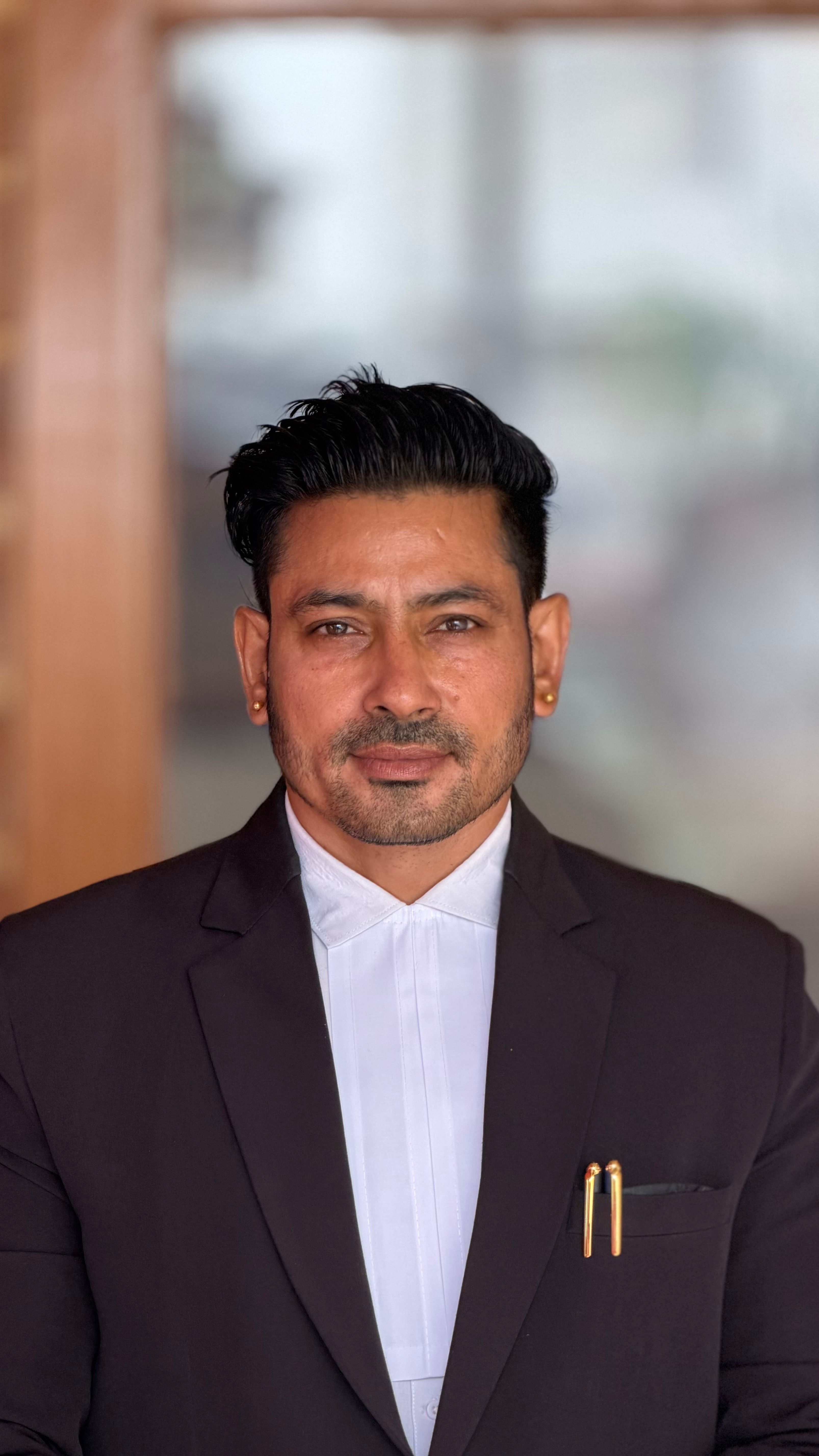 Confident businessman in formal suit posing indoors, expressing professionalism.