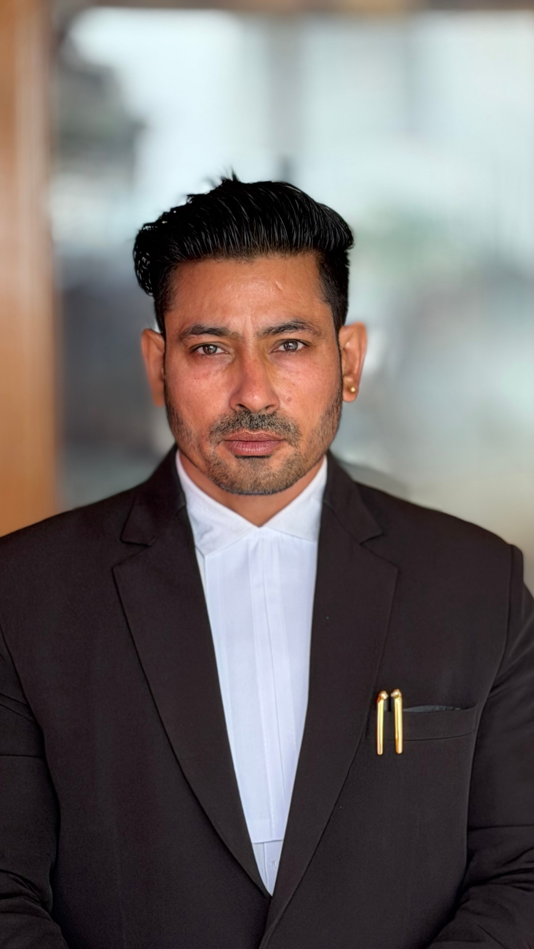 Confident businessman in formal attire with a focused expression.