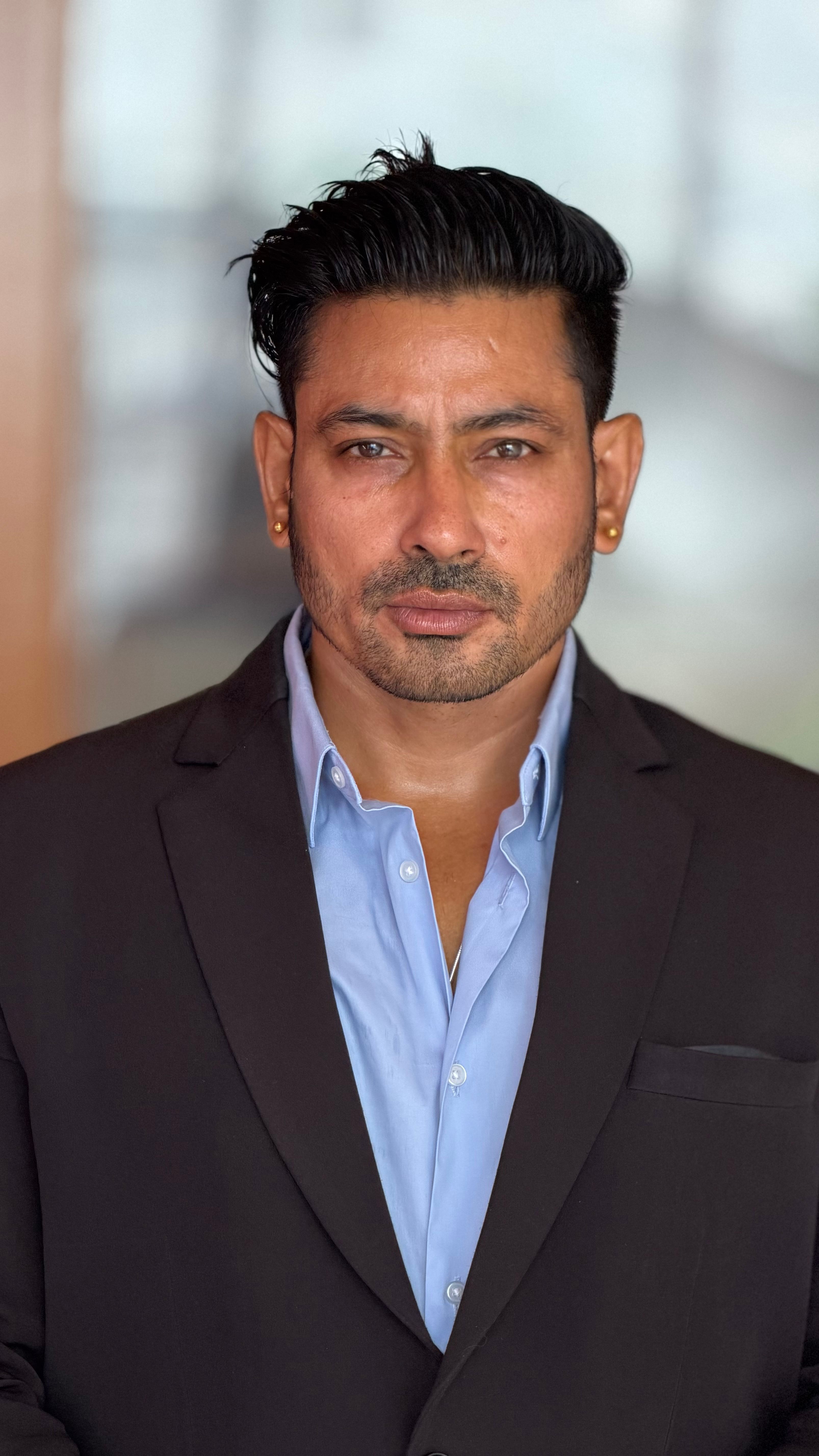 Portrait of a confident business man in a suit with a serious expression.