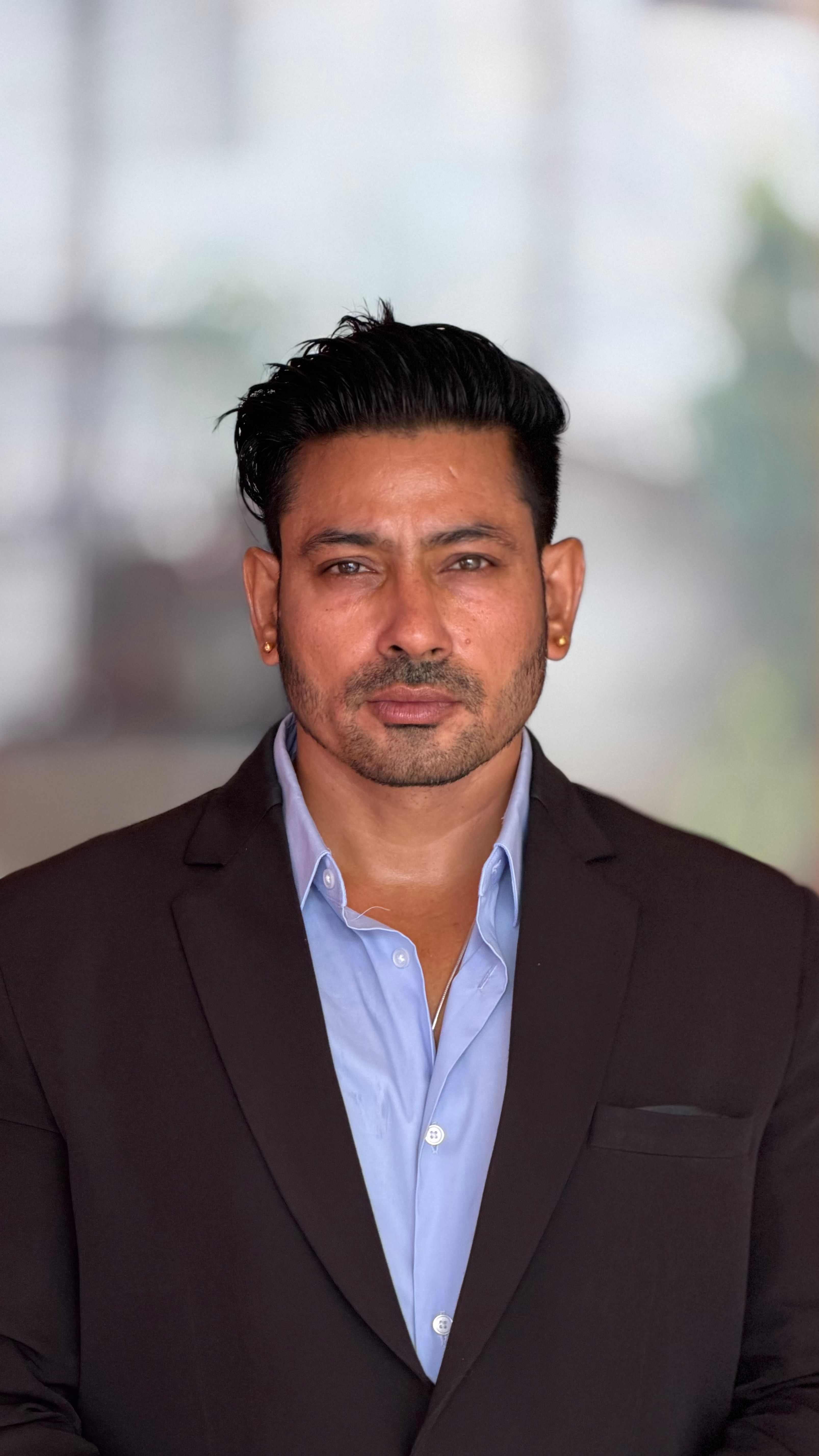Portrait of a confident businessman posing in a modern setting with a formal suit.