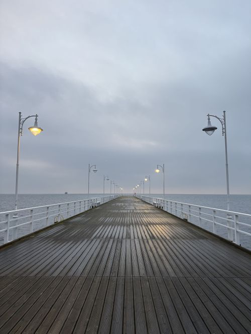 Free A serene view of a wooden pier stretching into the Baltic Sea at Jurata, Poland. Stock Photo