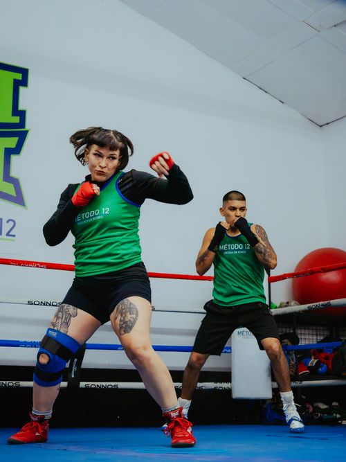 Free Focused training session in a boxing gym with two athletes in action. Stock Photo