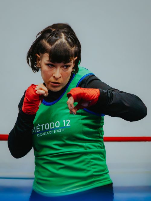 Free Intense female boxer practicing punches at Método 12 Escuela de Boxeo in Buenos Aires. Stock Photo