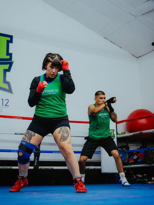 Free Two adults engaging in a focused boxing workout at an indoor gym in Buenos Aires, Argentina. Stock Photo