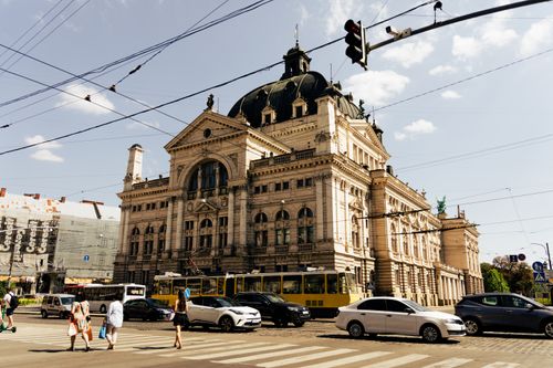 Free Bustling street view in Lviv, featuring historic architecture and urban life under a bright sky. Stock Photo