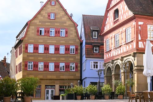 Free Colorful historic buildings in Winnenden, Baden-Württemberg with plants and outdoor seating. Stock Photo