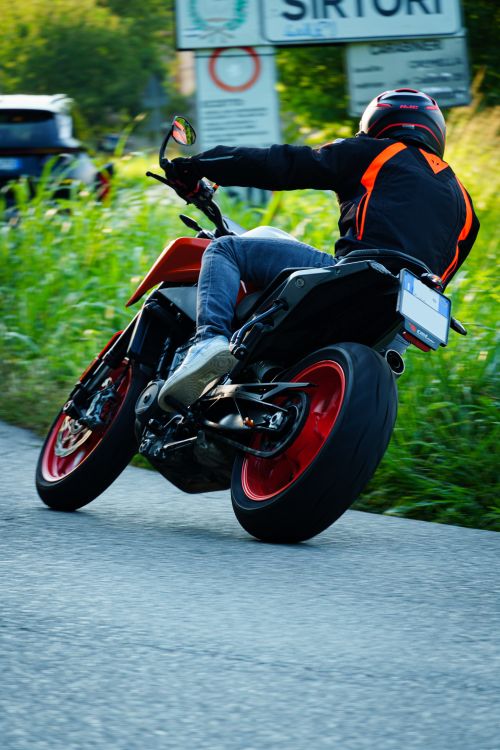 Free A motorcyclist leaning into a turn on a winding road, showcasing speed and agility. Stock Photo