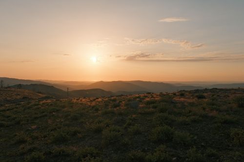 Free Captivating sunset view over rolling hills in Monção, Portugal, casting a warm glow. Stock Photo